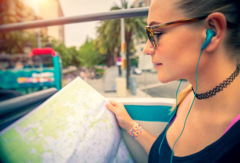 Woman listening to audio description through ear buds